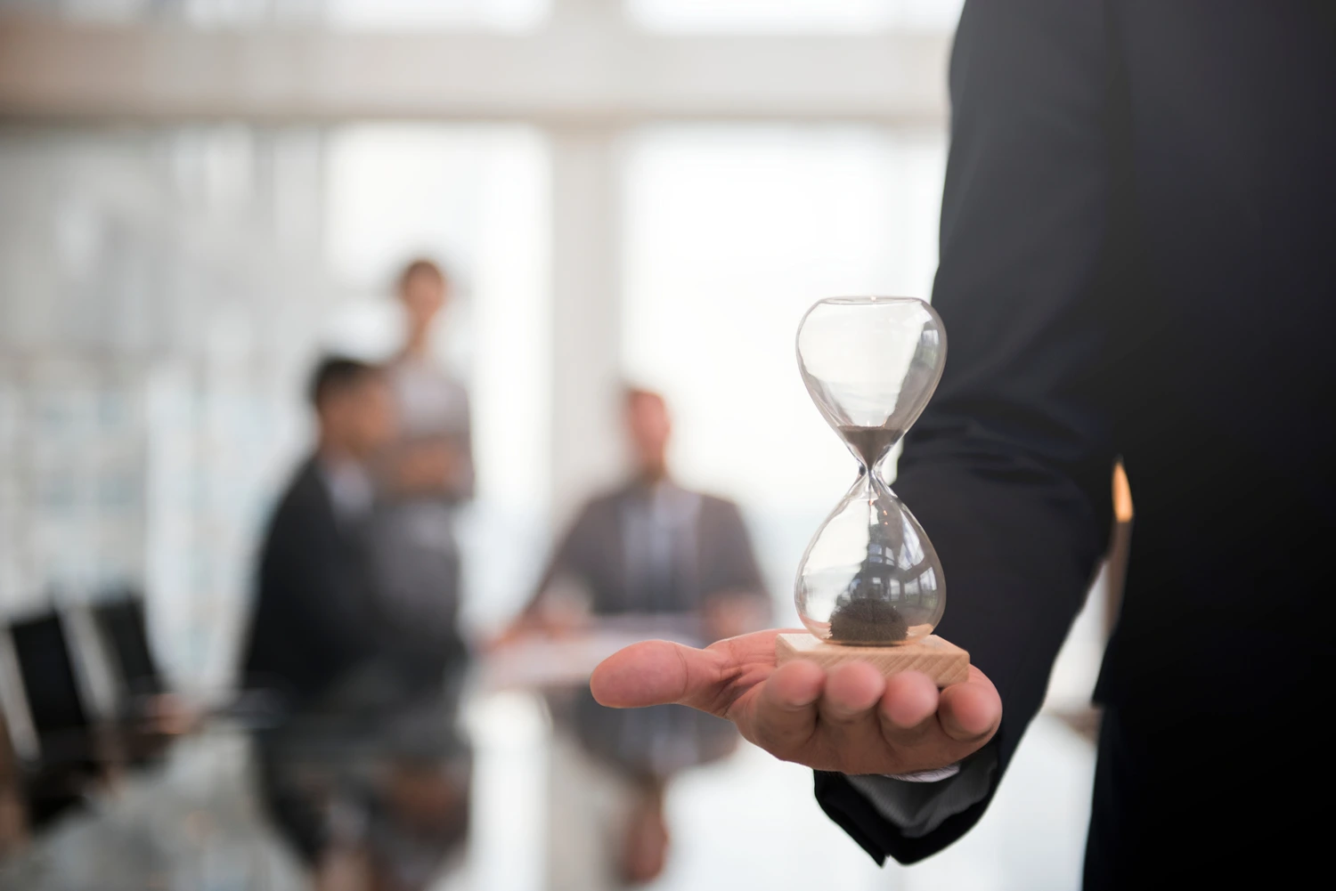 businessman holding hour glass signifies importance being time